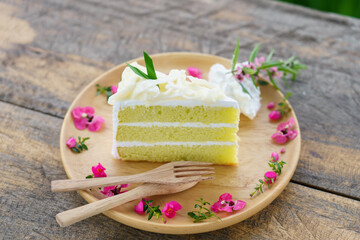 Slice of Coconut butter cream cake. Tasty homemade soft and delicious chiffon cake on table wooden...