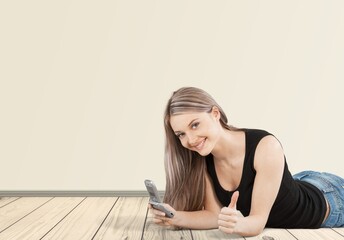 Young cheerful smiling successful woman with phone