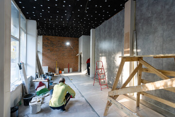 Builder puts the tiles on the floor, the repair