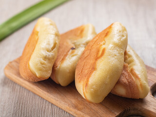 Kue Pukis, is an Indonesian traditional cake served on a wooden tray. Pukis is made of a wheat flour-based batter and cooked in a special mold pan similar to muffin tin.