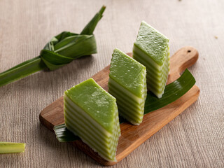 Lapis beras or kue pepe an Indonesian traditional dessert and street food served on a wooden tray. ...
