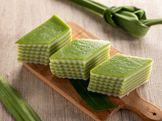 Lapis beras or kue pepe an Indonesian traditional dessert and street food served on a wooden tray. ...