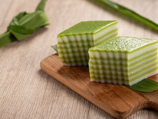 Lapis beras or kue pepe an Indonesian traditional dessert and street food served on a wooden tray. ...