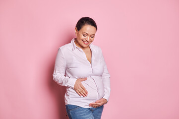 Confident portrait of emotional happy gravid female, smiling with beautiful toothy smile while...
