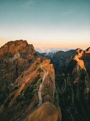Drone vertical view of person walking on the trail connects the highest points of the island