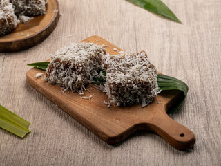 Indonesian traditional cake Ongol Ongol is served on a wooden tray or clay plate. made from grated...