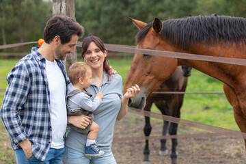 happy young family with a little son in a farm