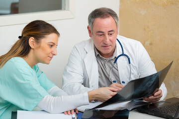 doctor and xray technologist re-inspecting a result