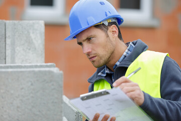 serious building inspector looking at new property