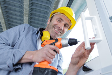 portrait of happy man in uniform working with electrical screwdriver