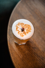 cup of coffee, cappuccino on the table, latte in the cafe, menu, wood table with glass of coffee, beautiful white creamy coffee with decoration