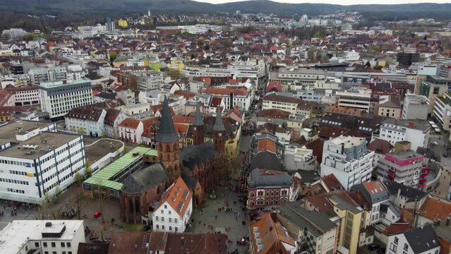 Aerial drone view of old city of Kaiserslautern, Germany while the FCK Kaiserslautern fans (  football match spectators ) crowding at a street intersection celebrating their win ( victory ) with beer