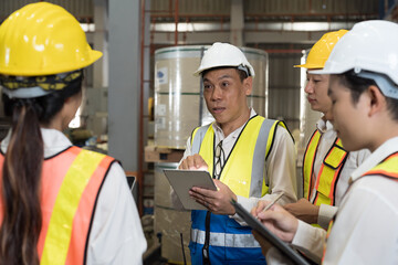 Manufacturing industrial concept. Asian male and female factory workers working and discuss at manufacturing production lines in factory during manufacturing process
