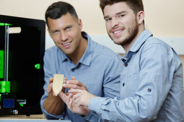workers showing product created by 3d printer