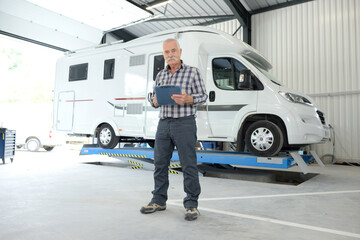 focused mechanic next to van