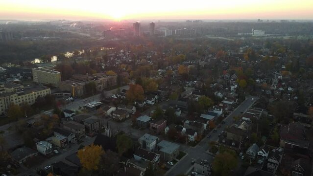 Drone footage of sunrise over a city neighbourhood in the morning