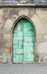 Fototapeta na wymiar Side door to the Magdeburg Cathedral with green copper plates