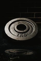 Fototapeta na wymiar Vertical shot of a 1 kg metal plate