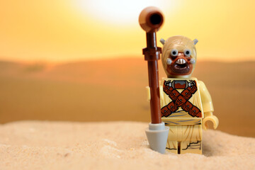 Fototapeta premium Lego Star Wars figure Sand People Tusken Raider stands on the desert planet Tatooine
