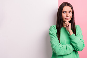 Photo of model young lady wear green pullover touch chin uncertain looking big wallpaper placard...