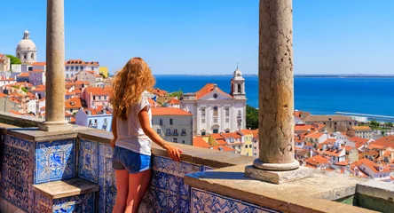 Fotobehang Woman tourist on balcony looking at panoramic view of Lisboa- Tourism,  vacation,  travel in Portugal © M.studio