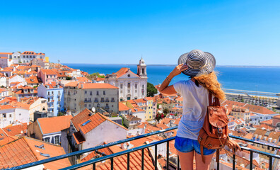 Woman tourist on balcony looking at panoramic view of Lisboa- Tourism,  vacation,  travel in Portugal - obrazy, fototapety, plakaty
