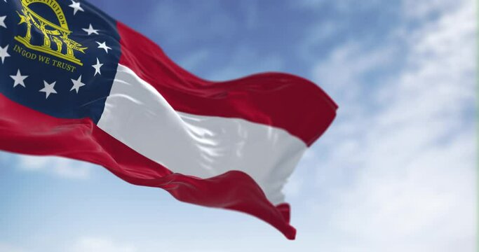 Seamless loop in slow motion of state flag of Georgia waving on a clear day