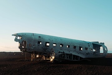 Abandoned and old plane in the field under the sun light.