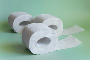 Soft toilet paper rolls on green background