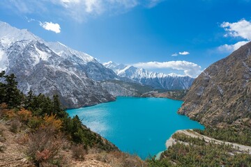 Scenic view of a blue lake in the middle of a mountain range
