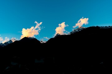 Scenic view of a silhouette of mountain range under the bright sky