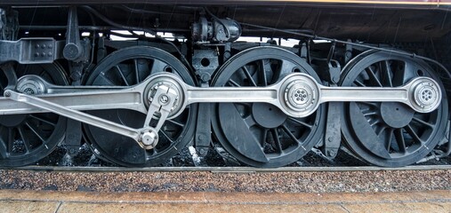 Close Up View of a Steam Train's Running Drive Wheels