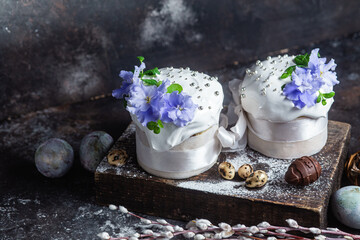 Easter cake with meringue and violets on a dark background