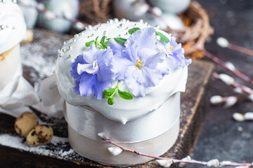 Easter cake with meringue and violets on a dark background