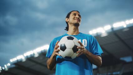Football Match Championship: Portrait of Soccer Player Holding a Ball, Standing, Posing, Smiling....