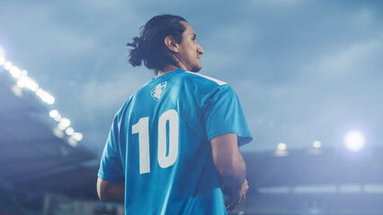 Football Match Championship: Portrait of Blue Team Soccer Player Holding a Ball, Standing, Smiling. Professional Hispanic Footballer, Future Champion Ready to Win Cup, Tournament. Medium Shot