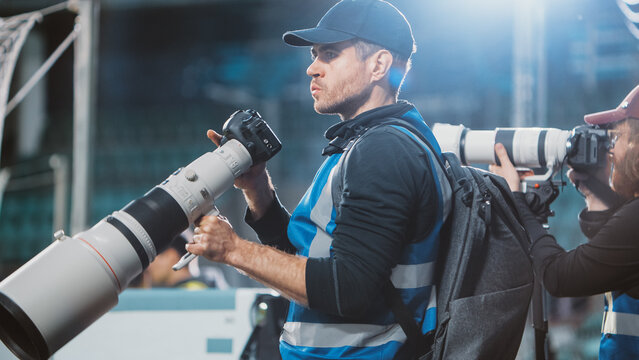 Professional Press Officer, Sports Photographers with Camera with Zoom Lens Shooting Football Championship Match on a Stadium. International Cup, World Tournament. Photography, Journalism and Media