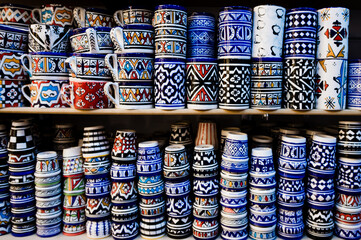 Fototapeta na wymiar Traditional Moroccan handmade crafts plates and cups in Marrakech medina souvenir shop