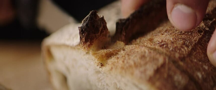 cutting bread in the kitchen closeup