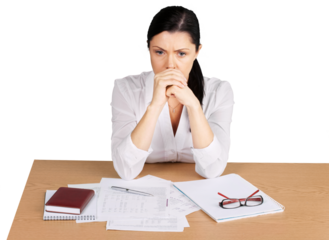 Businesswoman sitting at the table with many papers on background
