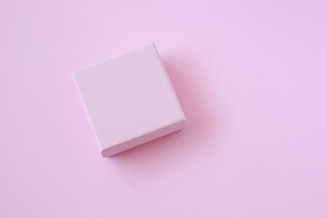 Pink present box on pink background, mockup