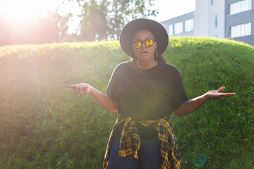 Close up portrait of happy african american young woman browsing social networks in city - generation z and urban concept