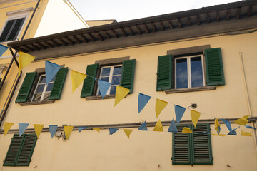 Facade of old buildings and ancient windows with arch in Venetian Gothic style in Pisa downtown, Italy, Europe.
