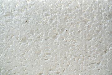 Texture of white styrofoam close-up. Universal insulation material made of expanded polystyrene