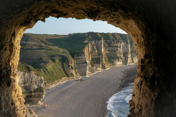 tunnel on the cliff with a view over a beach