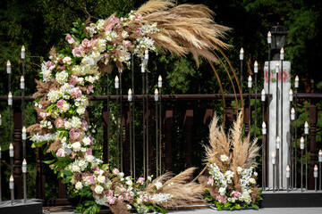 Beautiful round wedding arch decorated with flowers and greenery outdoors, copy space. Decorations...