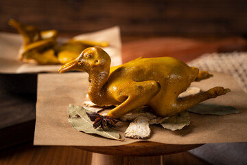 Pigeon meat marinated with spices, Chinese specialty food, shot in the kitchen, dark background,...