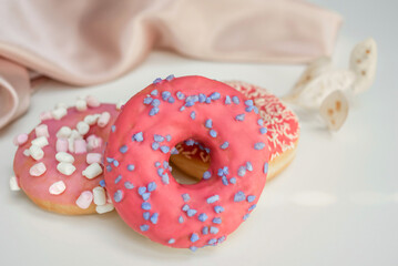 Delicious fresh donuts, pink icing on donut. Background image with donations and space for text