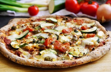 Fresh  homemade vegetarian Pizza, healthy pizza dough with wholemeal flour, sesame  and linseeds, topping with vegetables, mozzarella, hollandaise sauce and cashew nuts - 593943254