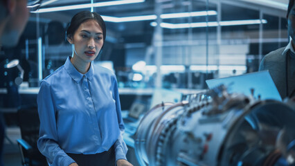 Young Diverse Multiethnic Asian Female Engineer Analyze How a Modern Electric Turbine Motor Works. High Tech Research Laboratory with Modern Equipment.